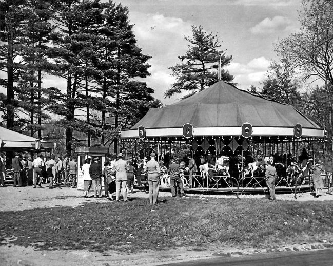 People riding the carousel at Pontoosuc Lake.